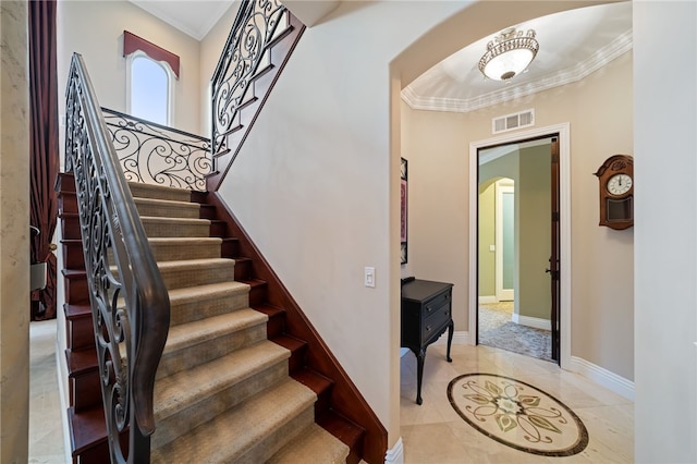 stairs featuring crown molding