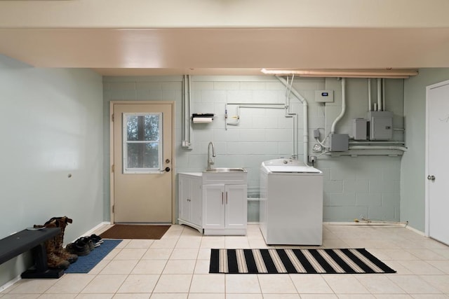 laundry area with washer / dryer, electric panel, cabinets, sink, and light tile patterned floors