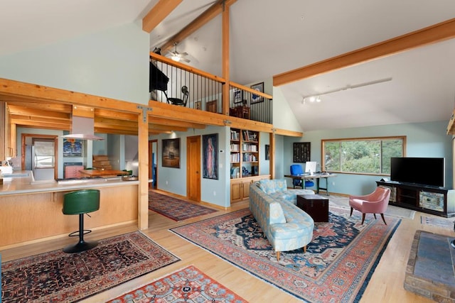 living room with high vaulted ceiling, light hardwood / wood-style floors, beam ceiling, and ceiling fan