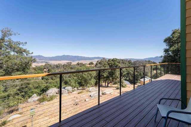 wooden deck featuring a mountain view