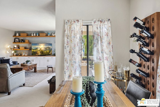 dining space featuring light carpet