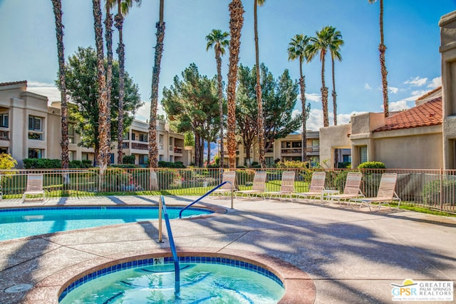 view of swimming pool with a community hot tub and a patio