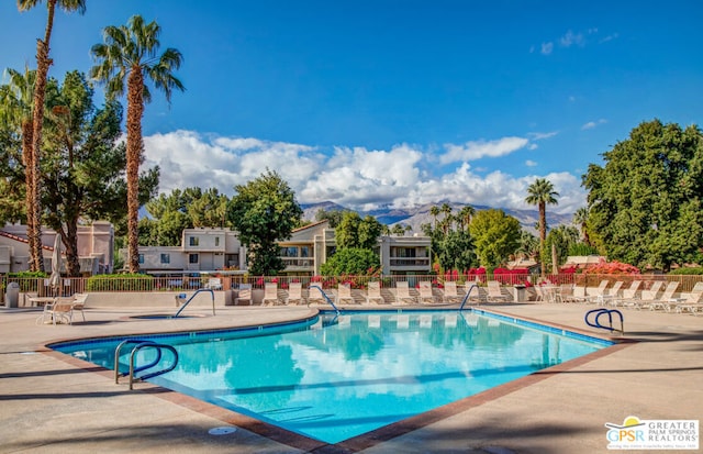 view of pool with a mountain view and a patio