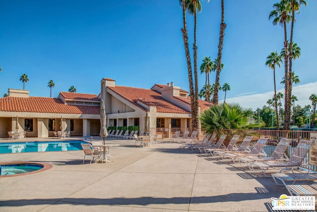 view of swimming pool with a patio and a hot tub