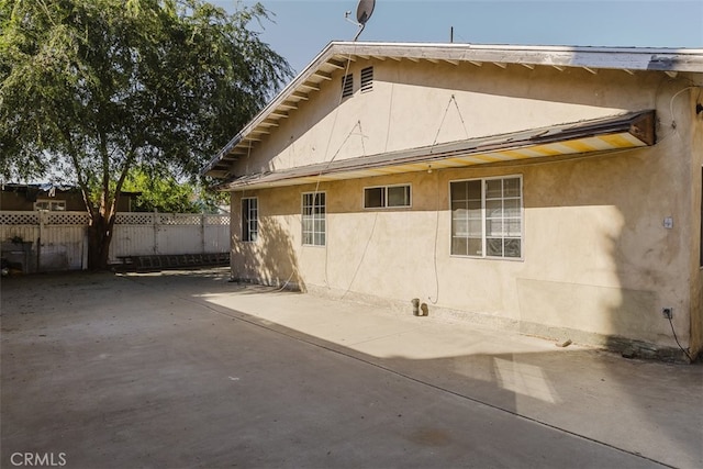 view of side of home with a patio area