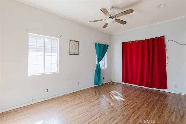 empty room featuring ceiling fan, crown molding, and hardwood / wood-style floors