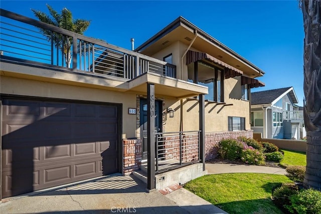 property entrance with a balcony and a garage