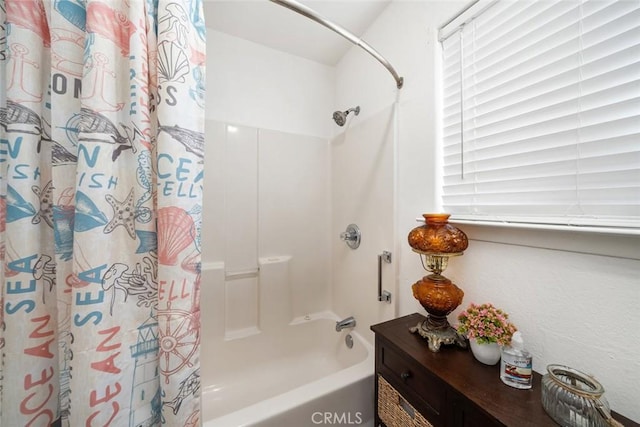 bathroom with shower / bath combo with shower curtain