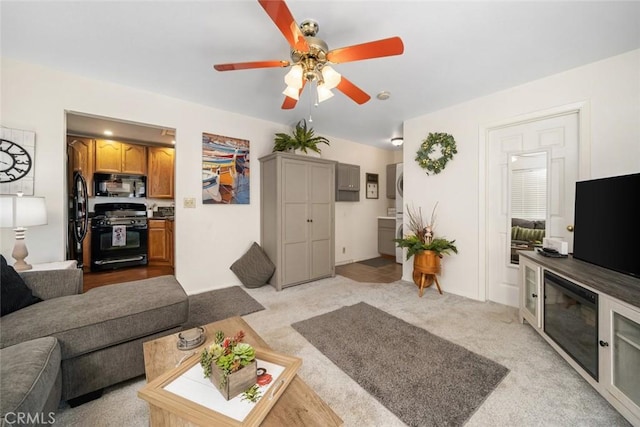 living room featuring ceiling fan and light carpet
