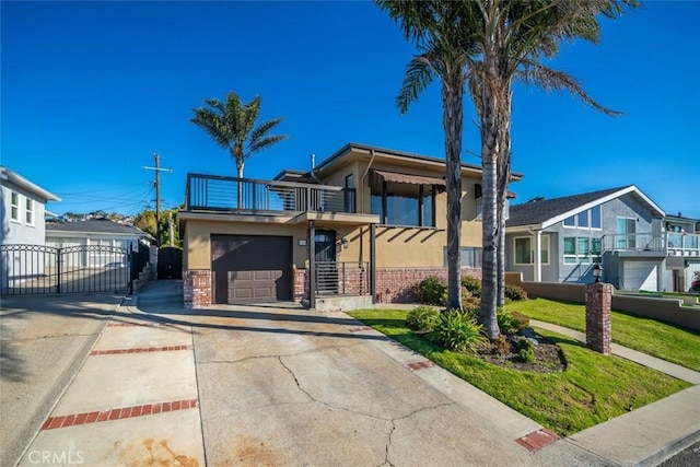 view of front of property featuring a garage and a balcony