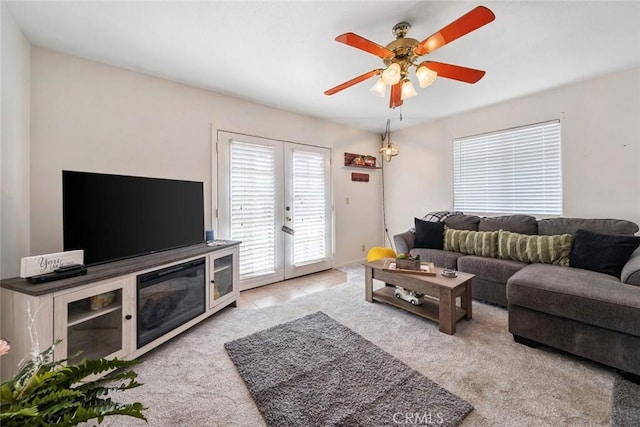 carpeted living room featuring french doors and ceiling fan