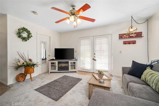 carpeted living room featuring ceiling fan