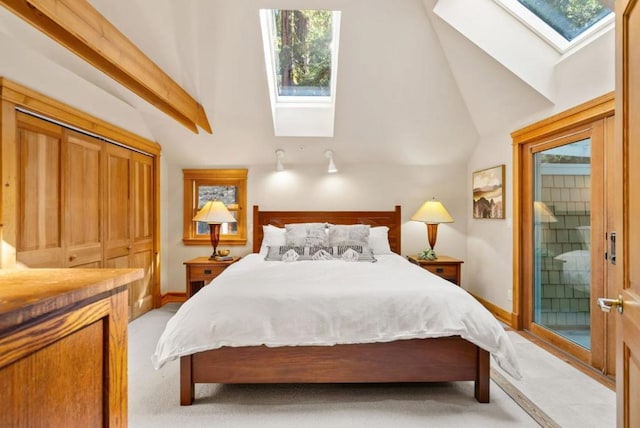 bedroom featuring light carpet, a closet, lofted ceiling with skylight, and multiple windows