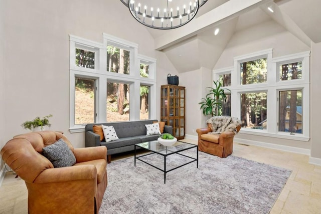 living room with beamed ceiling, high vaulted ceiling, and an inviting chandelier