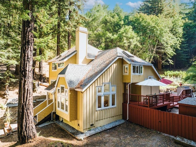 rear view of property featuring a deck