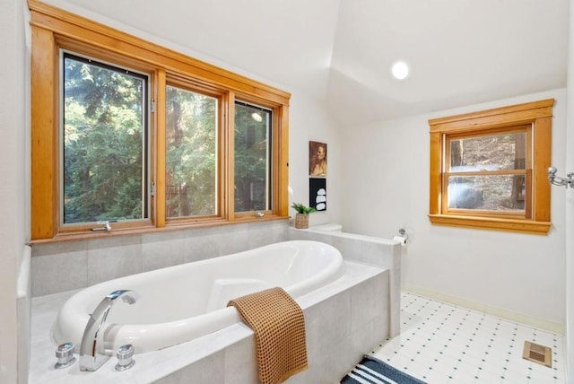 bathroom with tiled bath