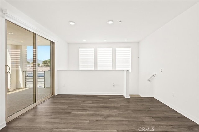 spare room featuring dark wood-type flooring