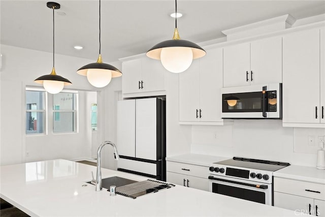 kitchen featuring stove, white cabinets, decorative light fixtures, and white refrigerator