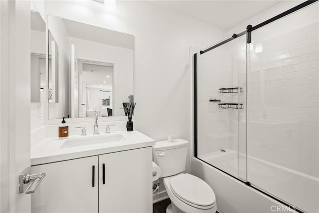 full bathroom with vanity, toilet, and bath / shower combo with glass door