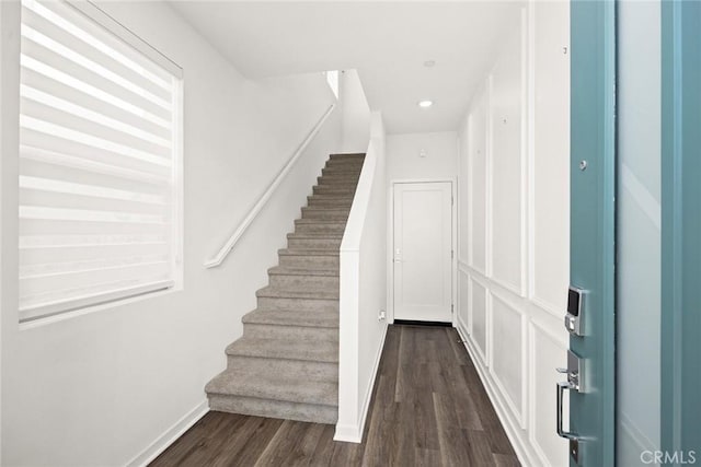 stairway with hardwood / wood-style floors