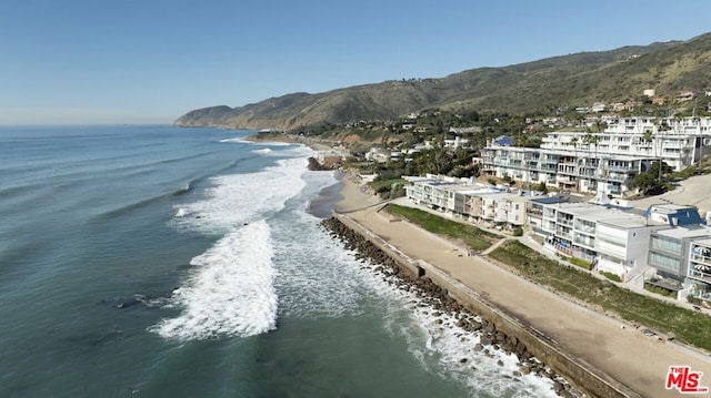 drone / aerial view featuring a water and mountain view