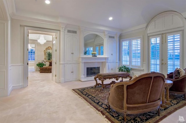 sitting room featuring light carpet and ornamental molding