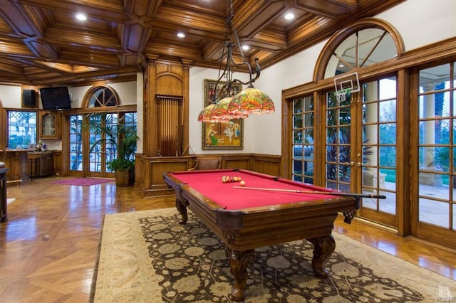 rec room featuring ornamental molding, coffered ceiling, light parquet floors, and french doors