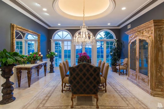 dining room with french doors, ornamental molding, a tray ceiling, and a chandelier