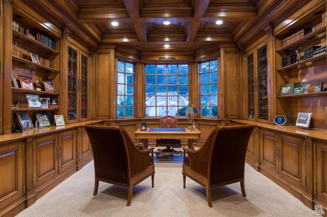 office featuring beam ceiling, ornamental molding, wooden walls, coffered ceiling, and light colored carpet