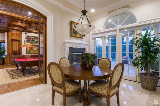 dining room featuring plenty of natural light, french doors, a high end fireplace, and ornamental molding