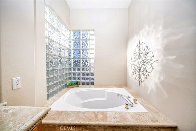 bathroom with a tub to relax in