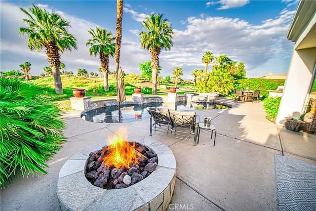 view of patio / terrace featuring an outdoor fire pit