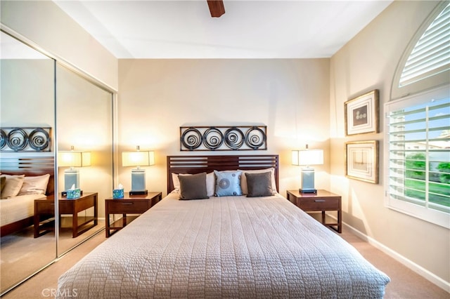 bedroom featuring ceiling fan, a closet, and carpet