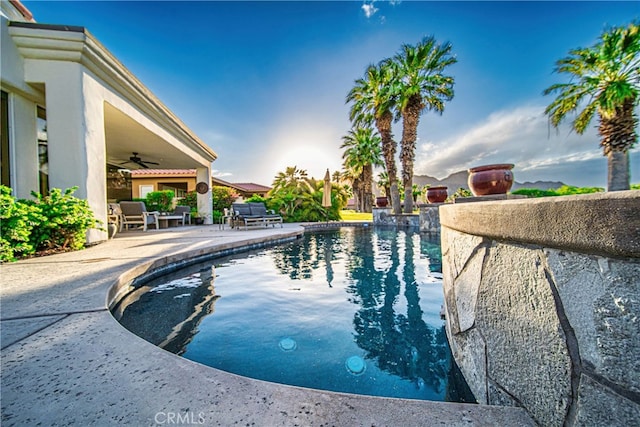 view of pool featuring ceiling fan and a patio area