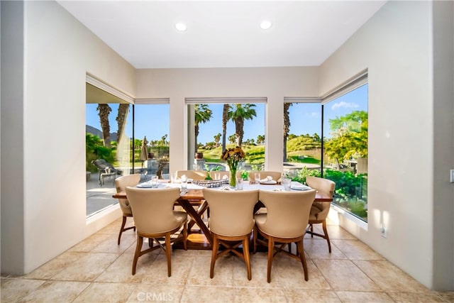 tiled dining space featuring plenty of natural light