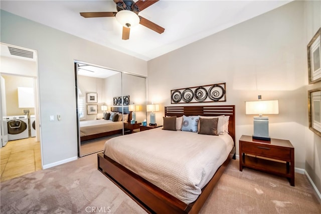 bedroom with washer and clothes dryer, lofted ceiling, ceiling fan, carpet floors, and a closet