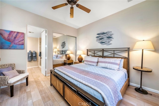 bedroom with ceiling fan, a closet, and light hardwood / wood-style floors