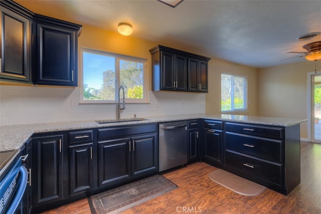 kitchen with wood-type flooring, dishwasher, plenty of natural light, and sink