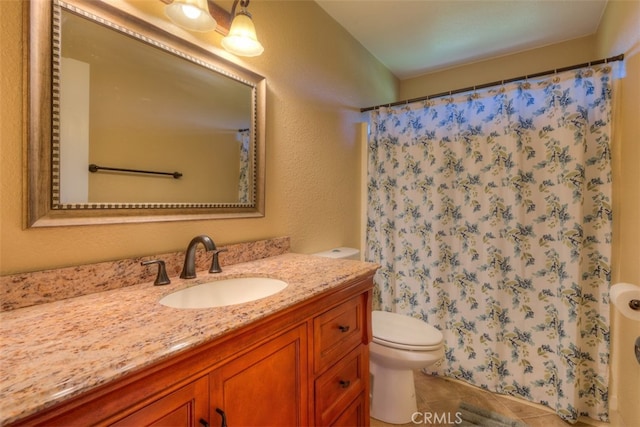 bathroom with tile patterned floors, vanity, and toilet