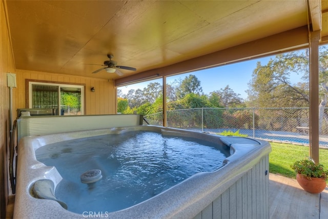 view of swimming pool featuring ceiling fan and a hot tub