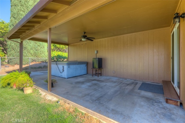 view of patio featuring ceiling fan and a hot tub