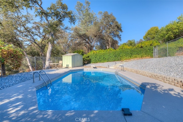 view of swimming pool featuring a storage shed