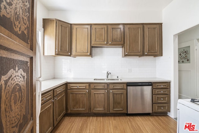 kitchen featuring dishwasher, white range, tasteful backsplash, sink, and light hardwood / wood-style flooring