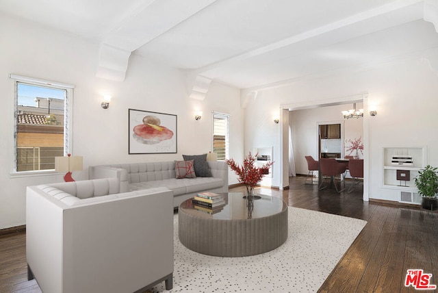 living room with dark hardwood / wood-style floors and a chandelier