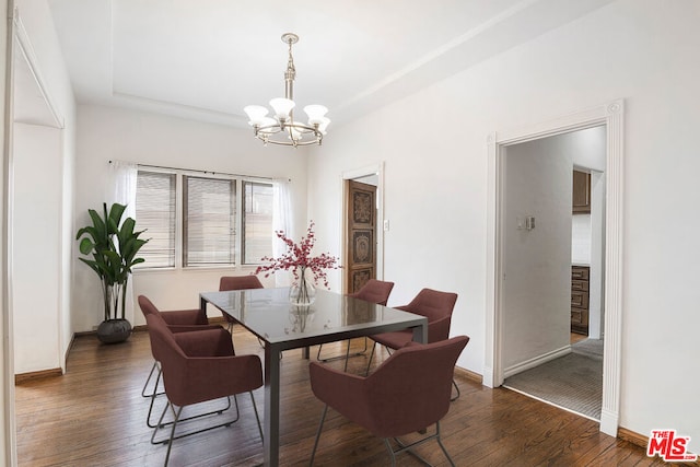 dining room featuring a chandelier and dark hardwood / wood-style floors