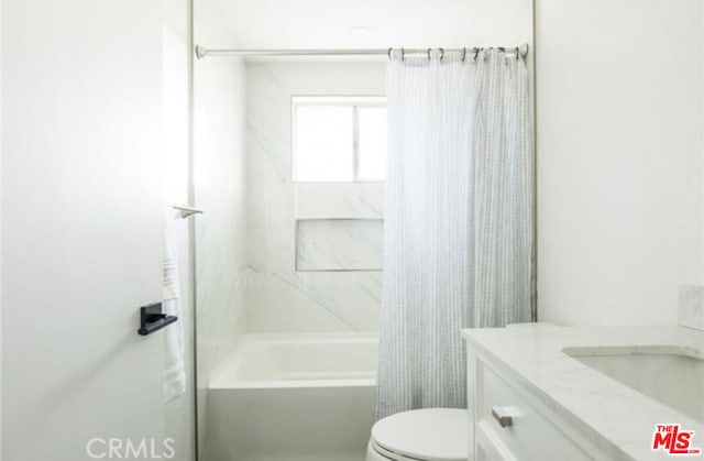 full bathroom featuring shower / bath combo, vanity, and toilet