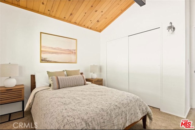 bedroom featuring light colored carpet, a closet, vaulted ceiling, and wooden ceiling