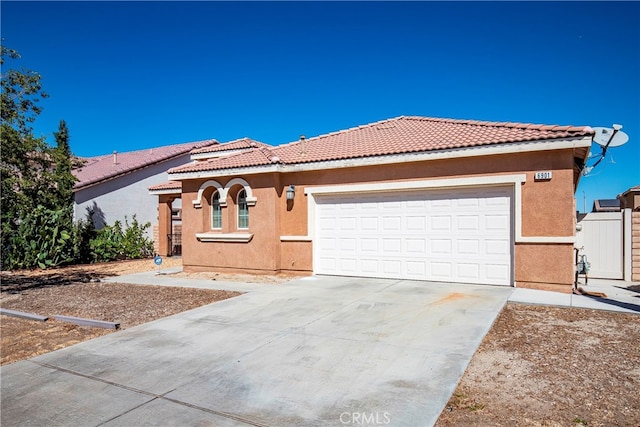 mediterranean / spanish-style home featuring a garage