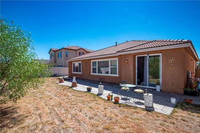 rear view of property featuring a patio