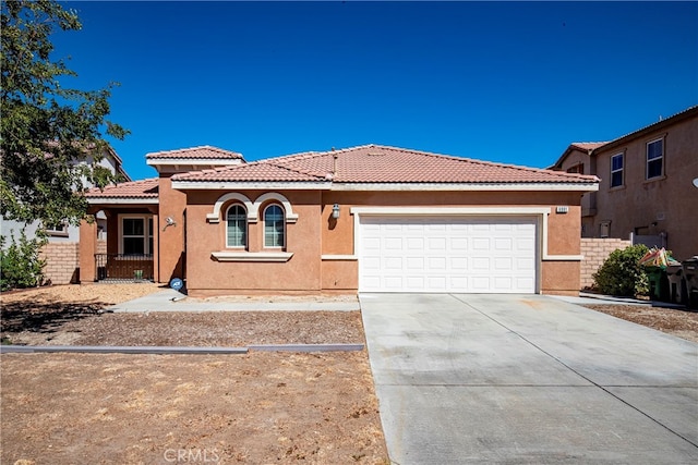 mediterranean / spanish home with a garage